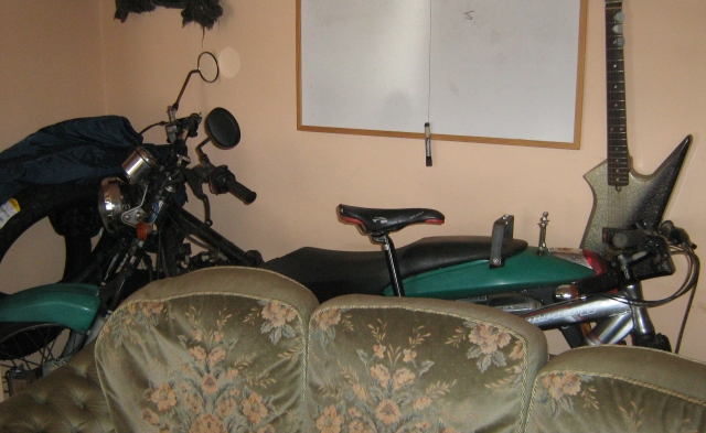 motorcycle behind the couch in the living room